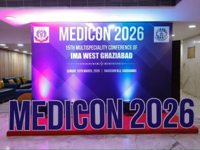 Promotional backdrop for MEDICON 2026 medical conference, with blue-purple geometric design and 'IMA West Ghaziabad' text.