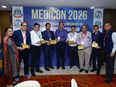 Group of ten professionals posing with award plaques in front of a MEDICON 2026 banner at a conference.